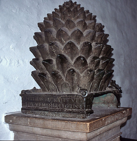 Bronze pine cone in the narthex of the cathedral at Aachen. This bronze sculpture may have been brought to Aachen from Italy at the time of Charlemagne, or it may have been cast in Germany as late as ca. 1000. It was inspired by the pine cone that once stood in the courtyard of Old St. Peter's Basilica and is now in the Cortile della pigna of the Vatican Museums.