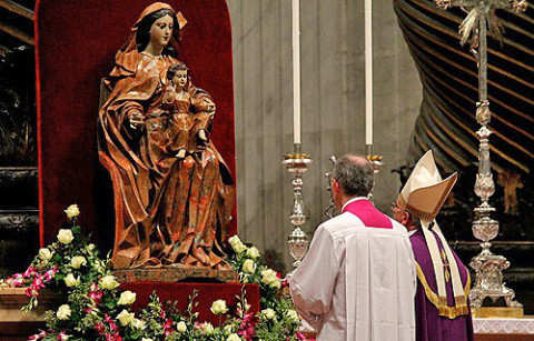 Pope Francis prays before a statue of Mary in St. Peters Basilica on Nov 30 2013