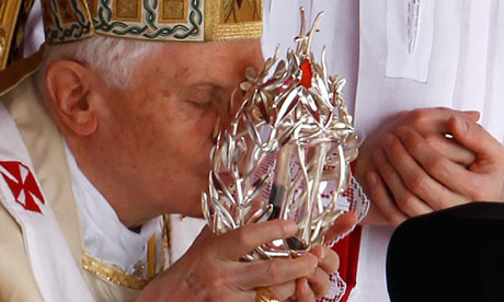 Pope Benedict XVI. kisses the glass reliquary containing blood of the late Pope John Paul